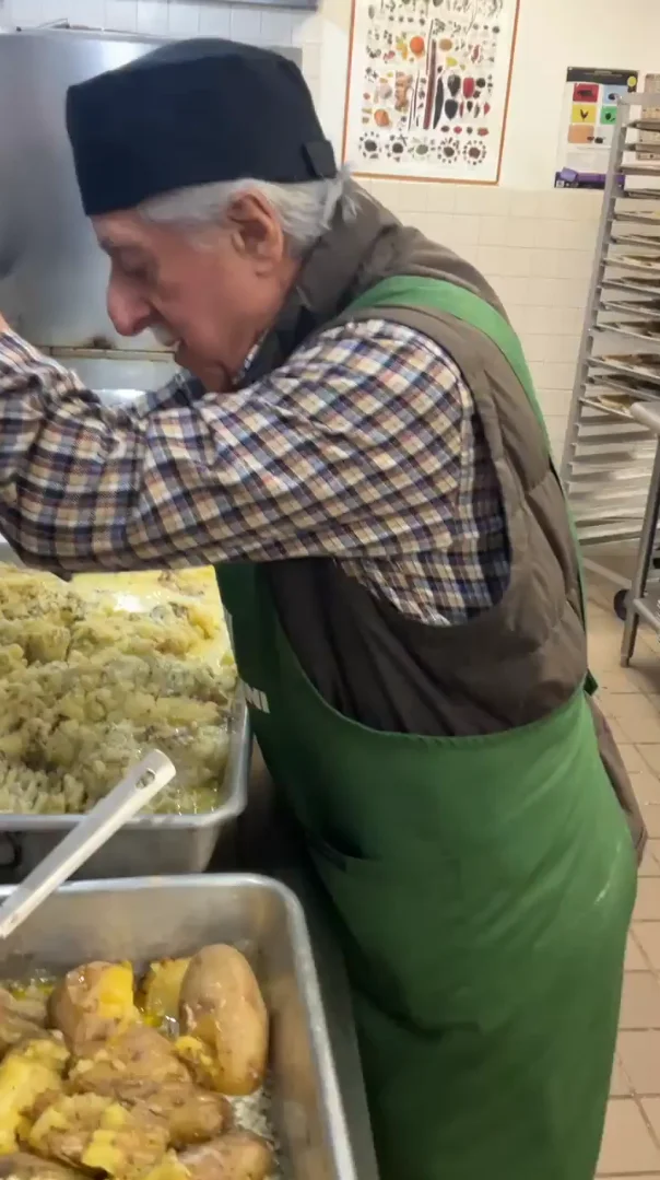 Hand-mashing the potatoes.