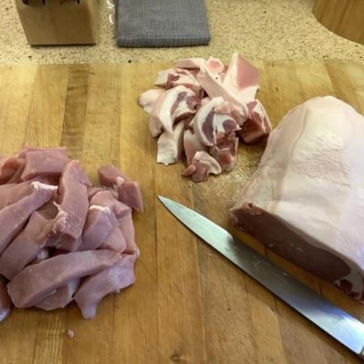 Boneless pork loins being trimmed.